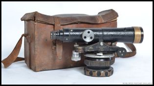 A vintage mid century leather cased theodolite  by ER Watts of London No 49336 mounted on pivot