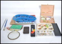 A collection of artists paints to include paint sets, pallets,