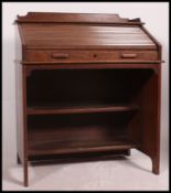 A 1920's oak Industrial roll top / clerks tambour office desk with appointed interior having