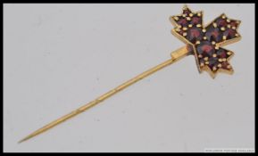A 22ct / 900 marked hi - carat gold and ruby hat - stick pin.