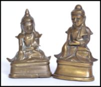 A 19th century Thai bronze buddha together with a near matching being hollow cast and engraved.