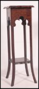 A vintage Edwardian oak torchere - plant stand being raised on for square tapered legs with lower