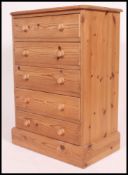 A good quality contemporary pine chest of drawers being raised on a plinth base with an upright