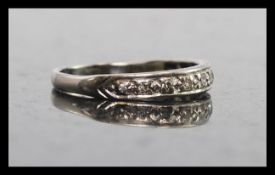 An 18ct white gold  and diamond half eternity ring. The ring with channel set stones approx 10pnts.