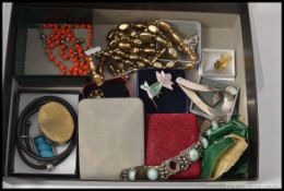 A box of costume jewellery to include silver brooch, pill box, white metal bracelet, brooches,