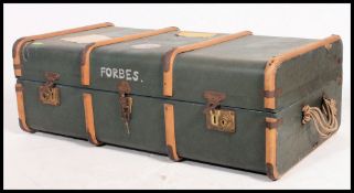 A vintage early 20th century canvas and and banded steamer trunk having notation to the case Forbes.