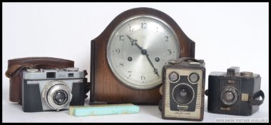 A mid 20th century eight day mantle clock along with a vintage Iloca camera,