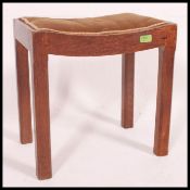 A 1930's oak dressing table stool in the Arts & Crafts style.