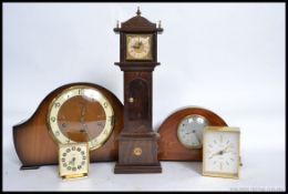 A 1940's mantel clock together with a miniature grandfather clock, Swiza alarm clock,