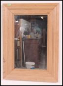 A large wall mounted distressed pine mirror being constructed from reclaimed wood,