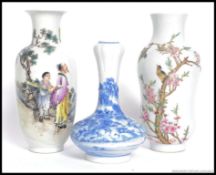 2 Chinese famille rose vases of baluster form having  scholars to one with character marks,