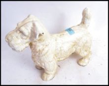 A large 20th century cast iron white painted model of a Scottie dog.