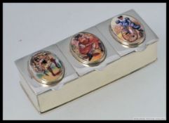 A silver white metal 925 three section pill box, enamel set, with images of dancing girls.