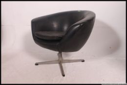 A retro 1970's chrome and faux leather tub salon swivel chair.