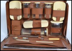 An early 20th century Edwardian gentlemen's leather Vanity travelling case with ivory brushes and