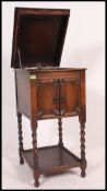 An oak cased Edwardian Academy upright gramophone, with accessories,