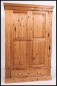 A good  contemporary country pine two door double wardrobe. The wardrobe with hanging space within.