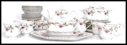 A 20th century Chinese chintz pattern part tea service to include cups, plates, tureens etc.