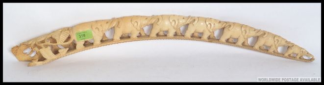 An early 20th century antique carved elephant tusk arch. 8 elephants with foliate carved end.