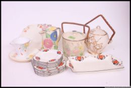 A collection of Art Deco ceramics to include biscuit barrels,