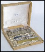 A mid century continental silver dressing table brush set with matching shoe horn displayed within