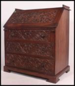 A finely carved mahogany colonial bureau the fall front containing fitted interior above three
