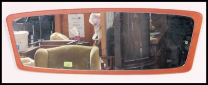 A vintage 1970's oval teak wall mirror.