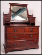 An Edwardian dressing chest with with Art Nouveau handles with central swing mirror flanked by