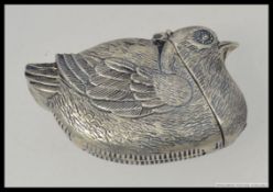 A silver plated vesta case in the form of a bird.