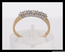 A 9ct gold and diamond ring set with approximately 25pt diamonds. Hallmarked GA Sheffield. Weight 1.