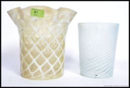 Two vintage early to mid century glass oil lamp shades to include a two tone fluted shade with a