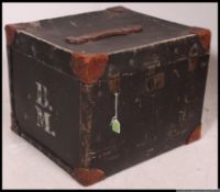An early 20th century ebonised canvas lined steamer trunk /  hat box with clasp to front,