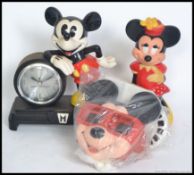 A collection of items relating to Walt Disney's Micky mouse, to include a Micky Mouse clock,