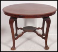 An Edwardian mahogany circular dining table.