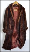 A vintage mid century ladies fur coat with lined interior bearing original labels for M Michaels of