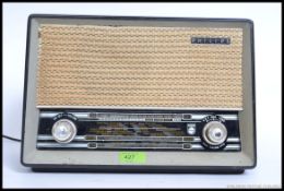 A vintage mid 20th century Philips bakelite valve type B3G75U radio having twist knob dials to the