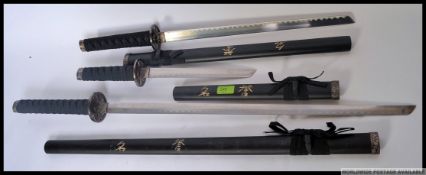 A set of three graduating Japanese display Samurai swords each with sheaf