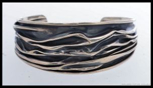 A contemporary decorative ladies bangle bracelet in the manner of Georg Jensen.