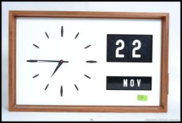 A vintage retro teak cased Industrial 1960's wall clock with changeable block date function