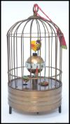 A vintage brass automaton style bird cage clock.
