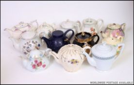 A large collection of teapots to include various shapes and patterns.