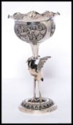 An unusual Chinese - asiatic silver goblet having stork to the stem with bowl atop having flanged