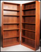A good quality large pair of retro teak wood upright bookcase cabinets.