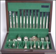 A 20th century mahogany cased canteen of cutlery ( see illustrations ).