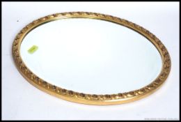 A 20th Century gilt surround wall mirror having an inset bevelled mirror panel 55x44cm