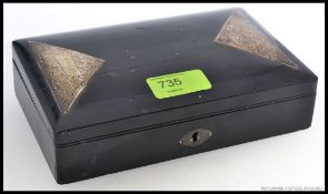 An ebonised jewellery box having silver hallmarked embellished chased  triangular panels,