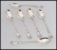 A set of 6 silver hallmarked spoons having embellished scrolled bowls and handles.