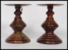 A pair of metal 20th century taza's of ribbed form with circular terraces to each.