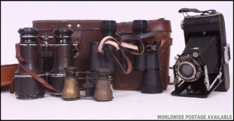 A collection of vintage 20th century binoculars to include leather cased examples together with an