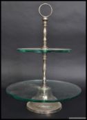 A silver plated and glass two sectioned cake stand.